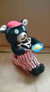 Japanese wind up toy..Bear in rocking chair eating porridge