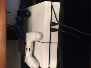 PS4 with 2 controllers and 4 games.