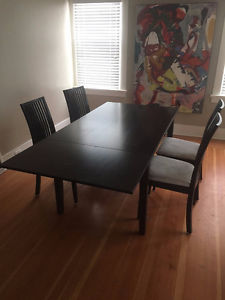 Solid dark wood table (expandable to seat 10) and 4 chairs.