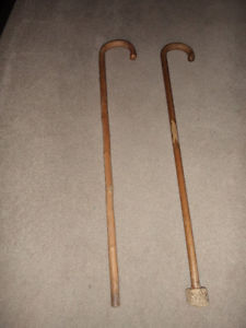 two 34 inch high wooden canes.. 5.00 for both