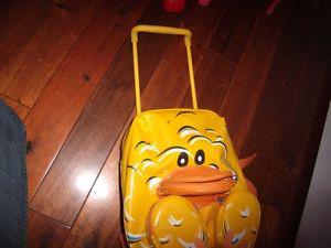 Duckie Suitcase with wheels, and extended handle.