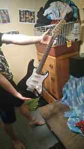 Electric guitar and small battery powerd amp with cable