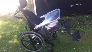Bucket style wheelchair with tray.