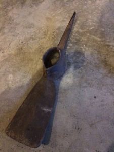 Old pickaxe heads and hay cutting tool
