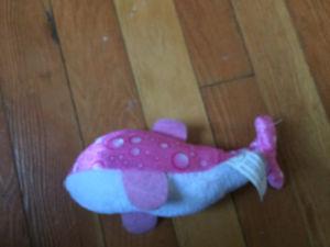Two pink dolphin stuffed animals