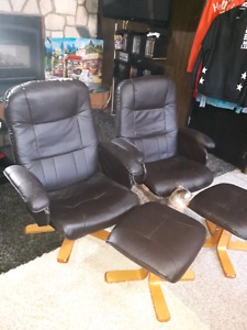 2 black chairs with foot rests