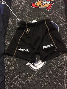 Brand new hockey shorts with a can for a child