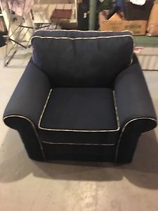 Blue fabric armchair with piping