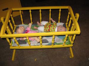 cradle with two dolls in it