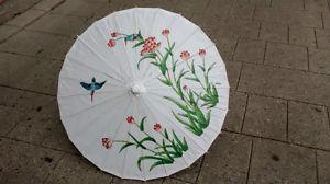 Paper parasols with pattern or white from $ ea