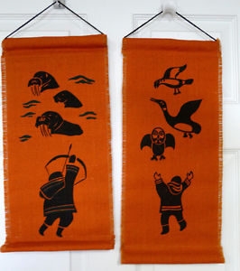 2 wall hangings Inuit Art on orange burlap
