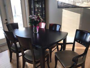 Expanding dining table and six chairs