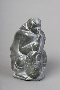 "Woman Inflating Seal Float" Inuit Carving