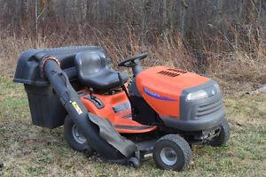Husqvarna ride on with all accessories plus a push mower.