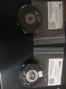Lot of 2 signed and authenticated hockey pucks