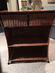 Wicker cabinet with wooden top.