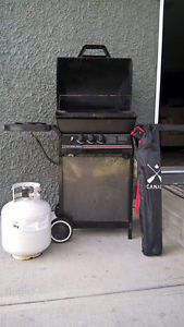 Barbecue, propane tank and new chair.
