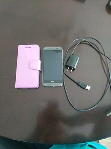 HTC One M8 with purple case and charger