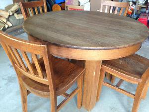 Solid oak round table and four chairs