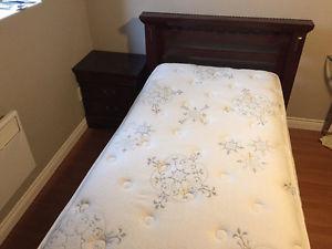 Twin bed with mattress and night stand
