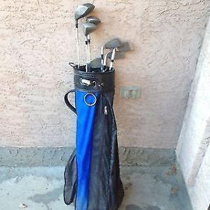 Blue GOLF bag and a few drivers and some clubs