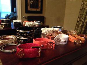 Various bracelets by Tory Burch, Hermes, and more