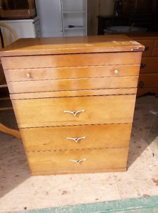 Wood dresser with four drawers.