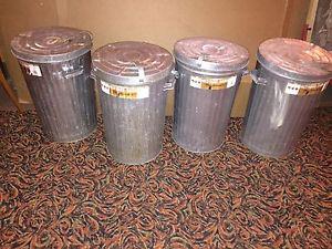 Four galvanized steel garbage cans