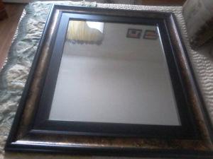 large heavy gold and black wood framed bevelled mirror