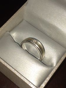 Silver wedding band with a Gold strip &a small diamond in