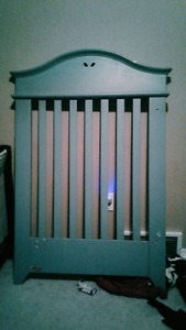 Baby blue crib that turns into toddler bed