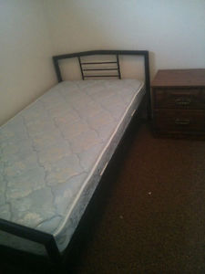 Single bed with mattress with free side table.