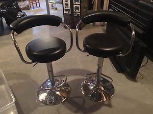 Two black bar stools