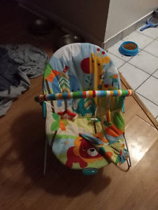 Bouncy chair with toys and boy clothes