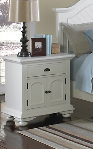 Twin bed with dresser mirror and nightstand.