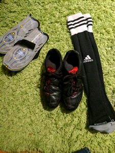 Youth soccer shoes, socks, and shin pads