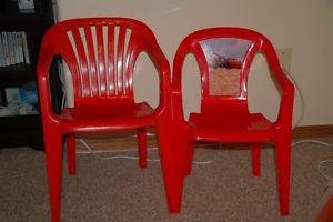 red plastic kids chairs. One with movie Cars picture