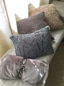 3 pillows and a throw blanket