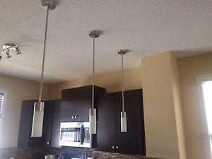 3 small pendant lights and one large pendant light