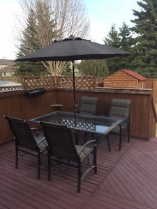 Back yard/Garden table with four chairs and one umbrella