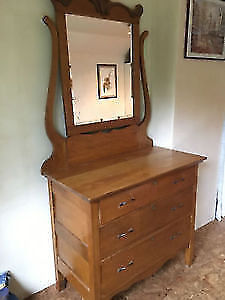 Curved antique dresser with mirror