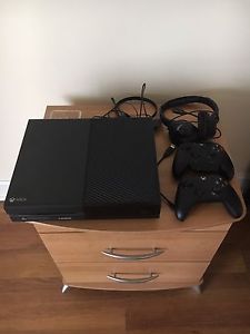 Xbox One with two controllers and two headsets