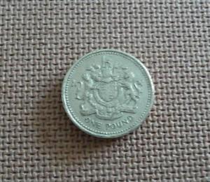1 pound coin  UK- Royal Arms representing the United