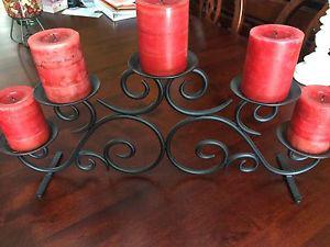 Black wrought iron candleholder with red candles