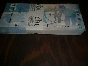 Uncirculated brick of 100 paper 5 dollar bills in sequence.
