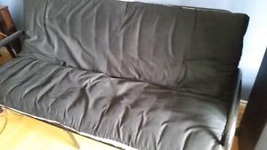 Futon couch folds easily into a bed.