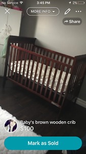 Brown crib with mattress