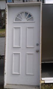 Steel entry door in frame with lock set and keys