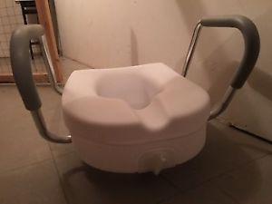 Raised toilet seat with padded handles