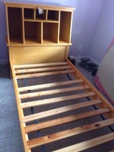 Bed frame. Single. Solid wood w/ built in bookshelf.